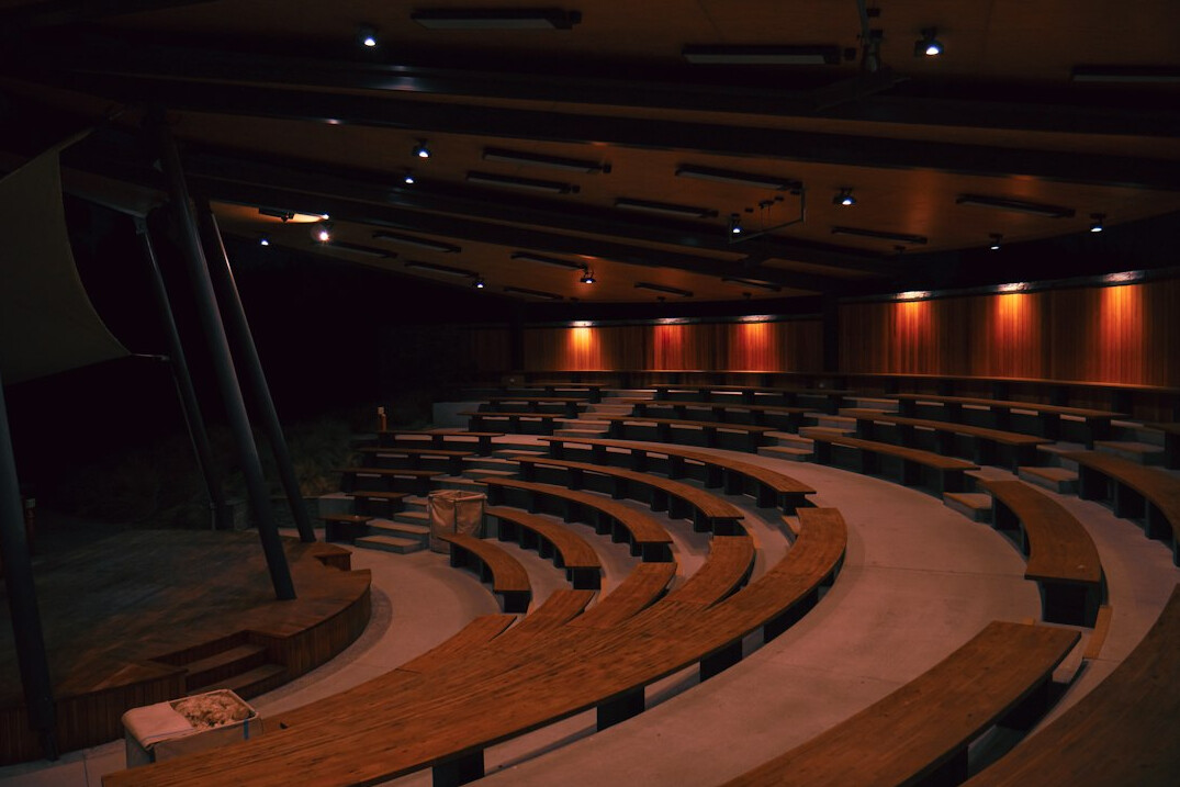 Empty television debate studio with desks and studio lights
